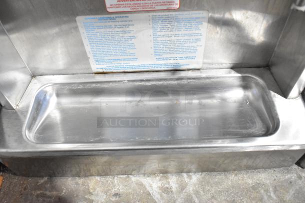 Taylor 340-27 stainless steel countertop frozen beverage machine drip tray, showing operating instructions label. Clean condition.