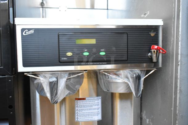 Curtis D1000GT63A000 stainless steel commercial countertop coffee machine. Features hot water dispenser, two brew baskets.