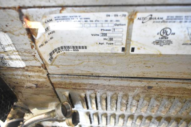 Alto Shaam AR-7T rotisserie oven label showing 208 volts, 1 phase, and serial number 2811153-000.