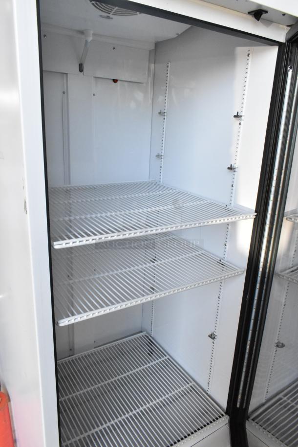 2021 True TSCI-600R-G-PH commercial single door reach-in cooler with poly-coated racks, 115V, excellent condition.