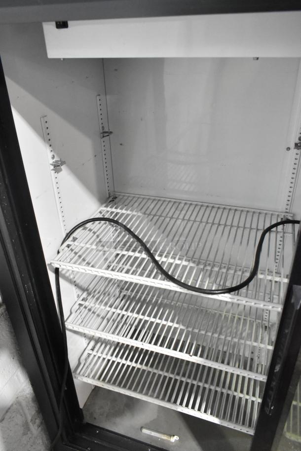 True GDM-41SL-60-LD commercial two-door cooler with poly-coated racks, 115 volts, 1 phase. Interior view, good condition.