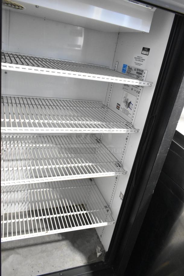 True GDM-41SL-60-LD commercial 2-door reach-in cooler with poly-coated racks, labeled 115 volts, 1 phase, in good condition.