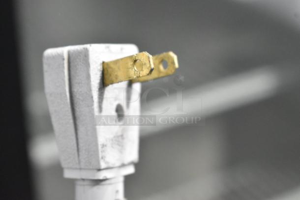 Close-up of a metal plug for True GDM-41SL-60-LD cooler, showing two prongs.