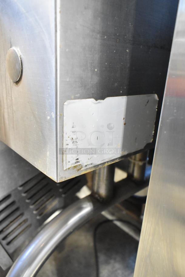 Cleveland Metal Commercial Tilting Braising Pan, stainless steel, visible wear, identification plate with faded text.