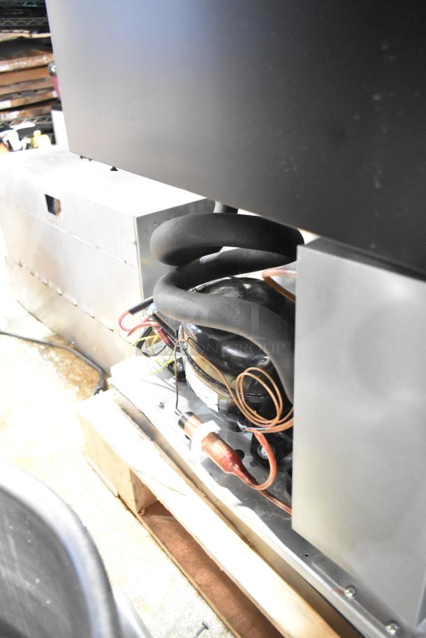 2025 Avantco 178UBB72SHC back bar refrigerator, close-up of black counter height model with visible internal components.