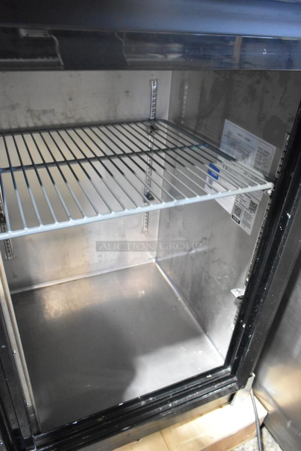Avantco 178UBB72SHC 73" black bar refrigerator, sliding glass door, LED lighting, 115V, interior label with specs visible.