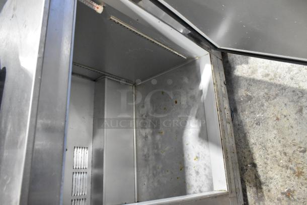 Beverage Air UCR48A stainless steel 2 door undercounter cooler, visible signs of wear, on commercial casters.