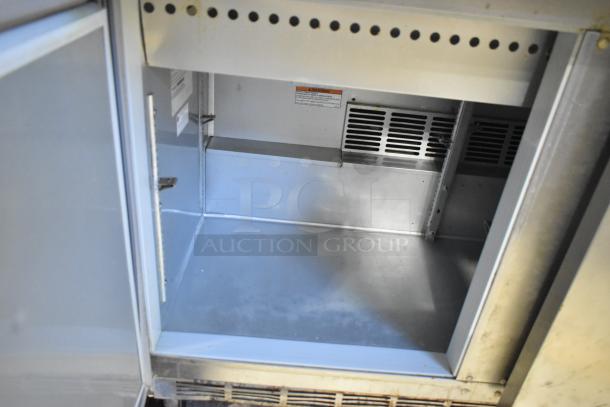 Beverage Air SPE48-18M-HMP prep table interior, stainless steel, clean, commercial casters, 115 volts, 1 phase.