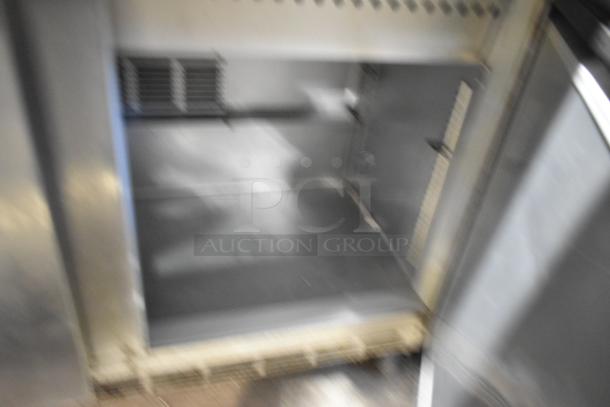 Beverage Air SPE48-18M-HMP stainless steel prep table interior. Features adjustable shelves. Condition: appears functional. 115V.