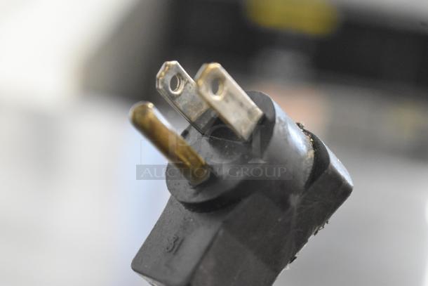 Close-up of a standard three-prong electrical plug for the Beverage Air WTR60A commercial cooler.