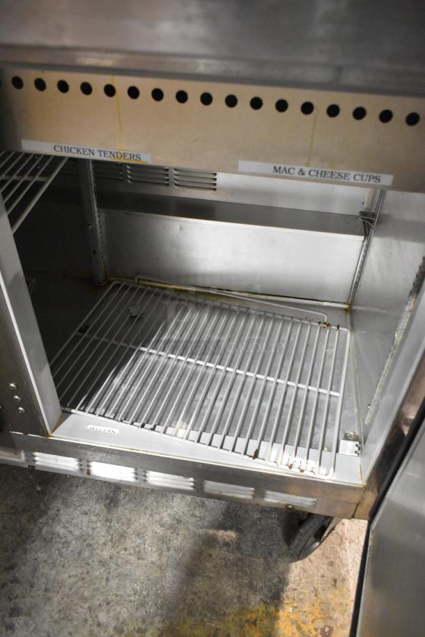 Beverage Air stainless steel prep table, Bain Marie mega top, on commercial casters. Includes labels for item organization.