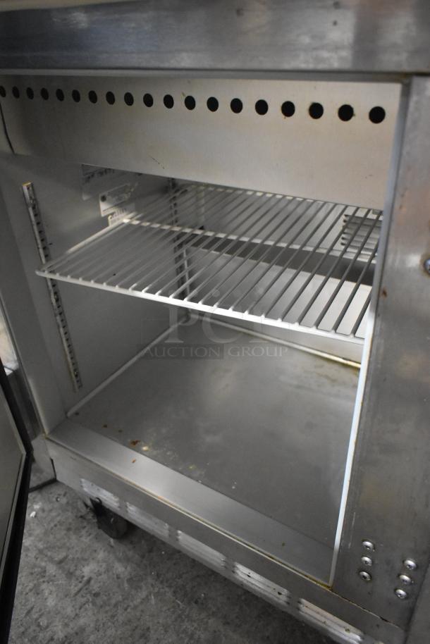 Beverage Air stainless steel commercial sandwich salad prep table on casters, interior shelves shown, 115V, 1 phase.