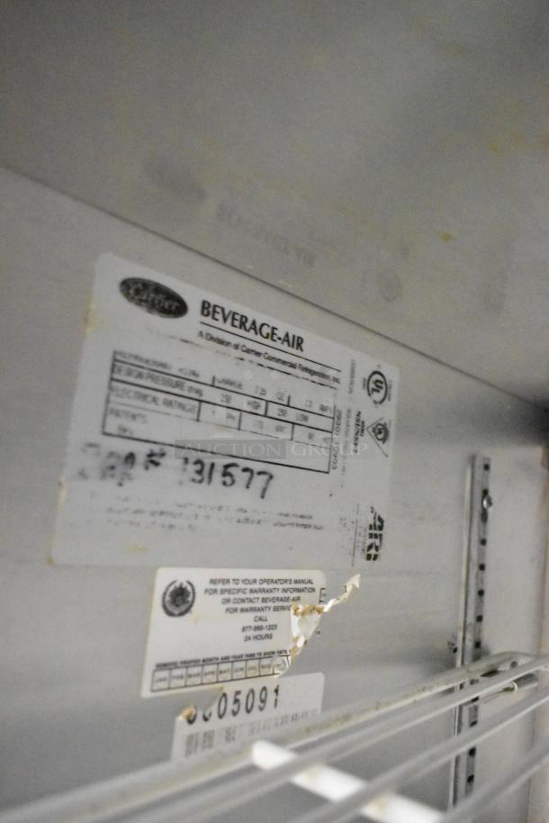 Beverage Air stainless steel commercial sandwich salad prep table with tags showing model details and specifications.