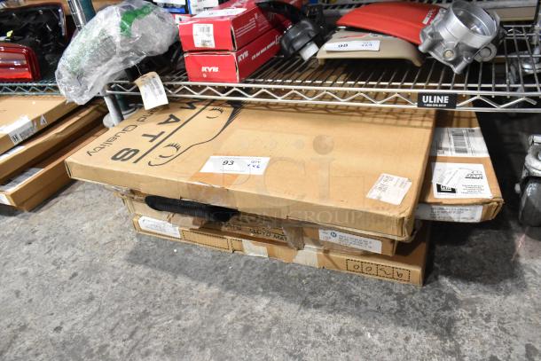 6 brand new scratch and dent items, including Lloyd Mats car mats on a shelf. Items in original packaging, labeled with product tags.