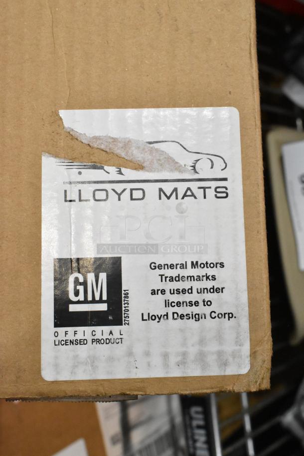 Cardboard box with Lloyd Mats label, featuring GM official licensed product marking. Items include scratch and dent condition.