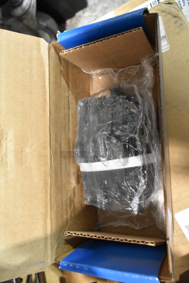 Three brand new scratch and dent items in a cardboard box, including Hawk HB528 P.811, HB250F.653, HB299 P.650, secured with plastic wrap.