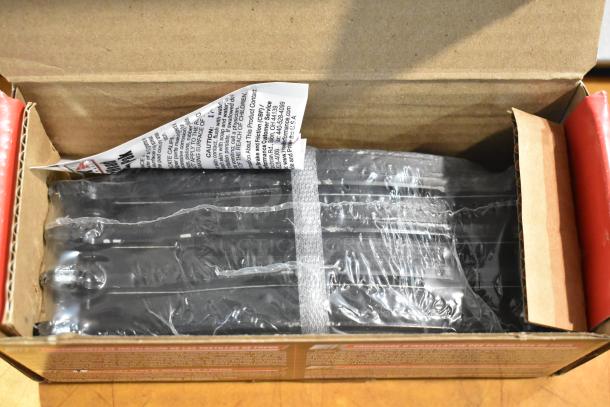 Box of new scratch and dent items, including Hawk models HB528 P.811, HB250F.653, HB299 P.650, in original packaging.