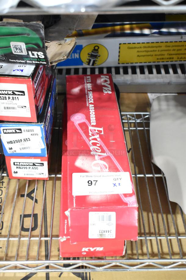 Brand new KYB 344403 Excel G Gas Shock Absorber in original red box, marked with "QTY 2" and "97" auction label.
