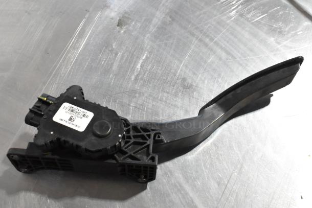 Brake pedal assembly with part label. Black, plastic, used condition. GM PN 22721400 noted.