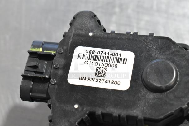 Black automotive part with barcode label showing GM P/N 22741800, model G100150008. Appears in used condition.