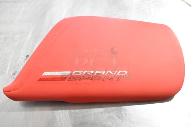 Red Grand Sport pad with embroidered logo, sleek design, in excellent condition, part of a four-item auction set.