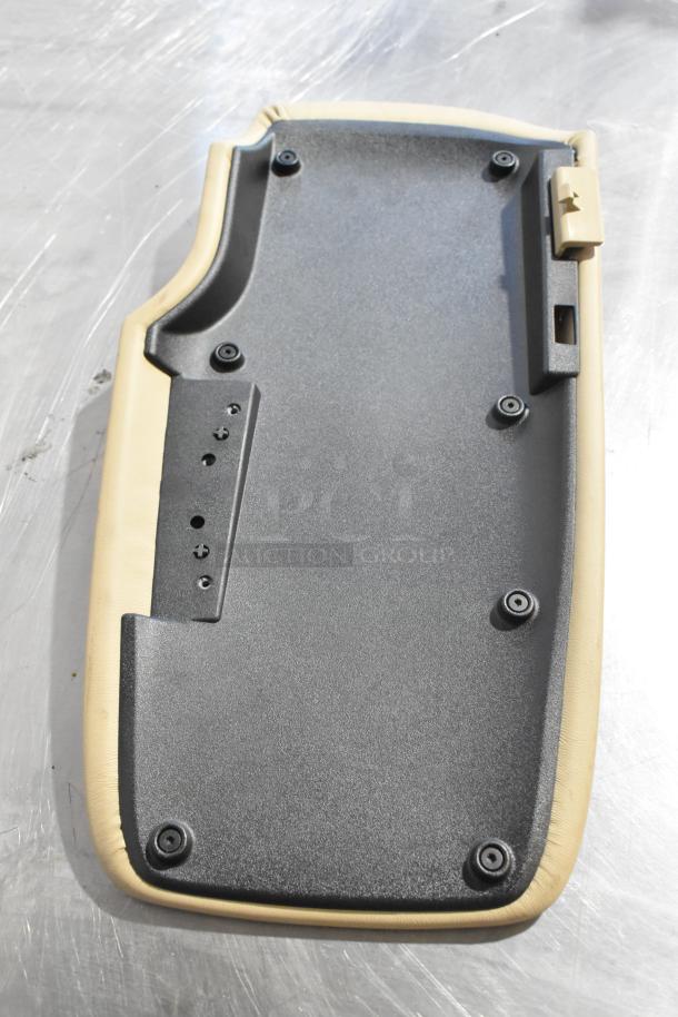 Beige and black automotive pad with mounting holes, in good condition. Part of a lot including a Grand Sport Pad.