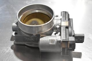 Metal unit featuring a circular opening, made of gray metal, in good condition. Visible barcode label on the side.