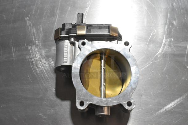 Heavy-duty metal unit featuring cylindrical components and a round opening, silver and brass tones, in good condition.