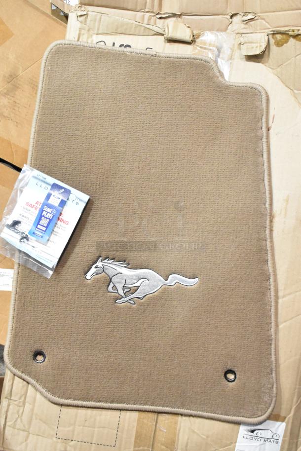 "New Lloyd Mats car mat with embroidered Mustang logo, beige color, includes original packaging, minor box wear visible."