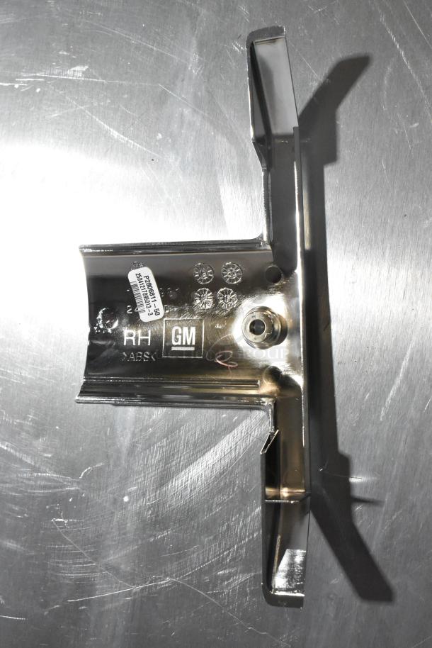 GM metal part with labels indicating "RH," "GM," and "ABS." Excellent condition, shiny finish. Includes part number P28066513.