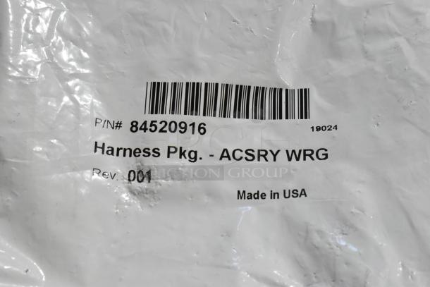 White package labeled "Harness Pkg. - ACSRY WRG" with P/N# 84520916, Rev. 001, Made in USA.