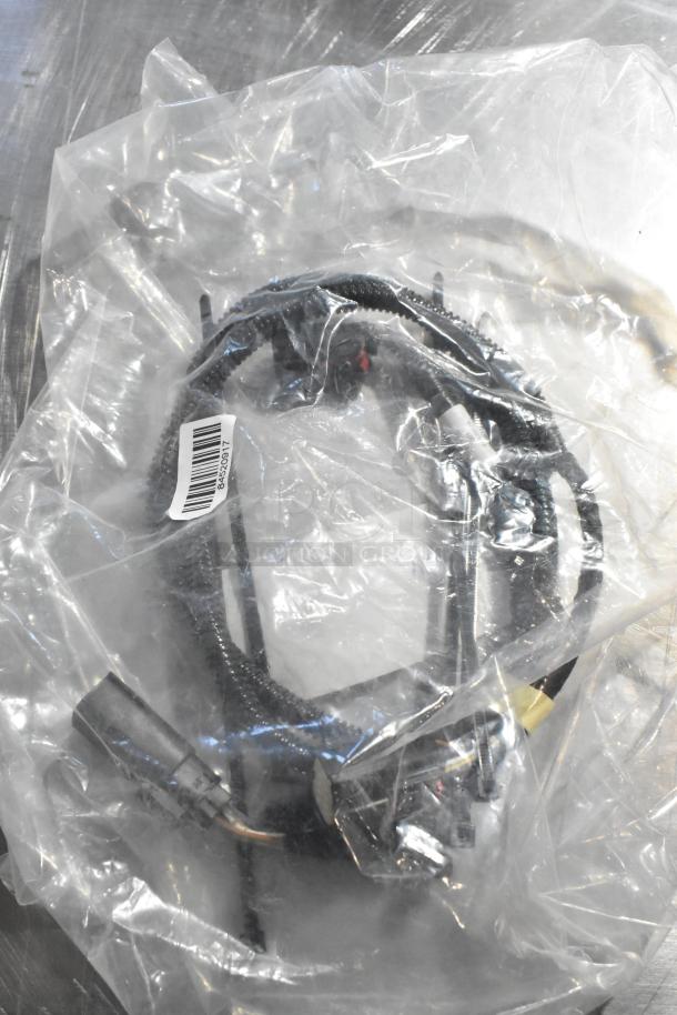 Three automotive parts including an oil additive, oil seal, and gear kit in sealed plastic bag with barcode label.