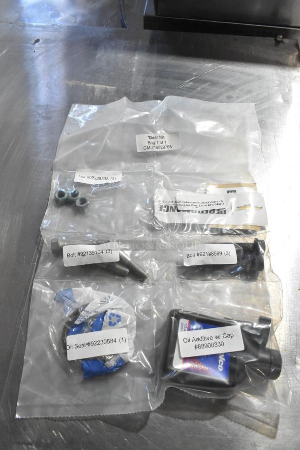 3 items including oil additive (#88900330), oil seal (#92230584), gear kit (GM #19329768) in plastic packaging.