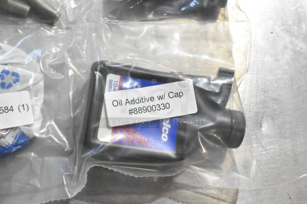 Oil Additive with cap, labeled #88900330, in sealed plastic packaging alongside additional items.