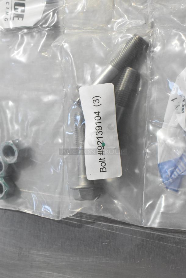 Packaged bolts labeled "Bolt #92139104 (3)," part of an auction set with oil additive, oil seal, gear kit.