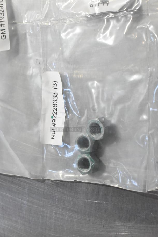 Clear bag with three metal nuts. Label reads "Nut #92228333 (3)." Items in new condition, key in gear kit.