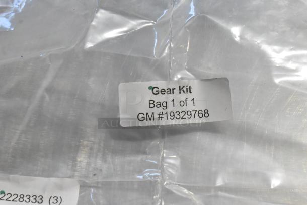 Bag labeled "Gear Kit, Bag 1 of 1, GM #19329768" showing part of a set including oil additive and oil seal.