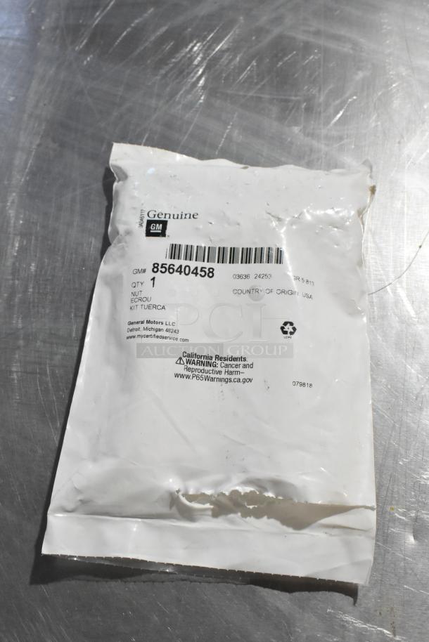 GM genuine hubcap bolt set package, model 85640458, new condition, one set, with warning labels visible.