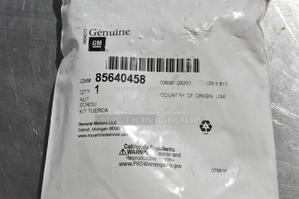 Genuine GM hubcap bolt set in sealed package, part number 85640458, includes one nut. Made in USA.
