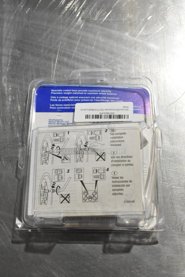 Plastic package of hubcap bolt sets with installation instructions. Label reads "Genuine GM Accessories 19211999 Wheel Lock Kit." Packaging appears new and sealed.