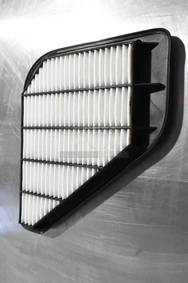 Air vent filter with black plastic frame, white pleated paper, in good condition, part of 3-item auction set.