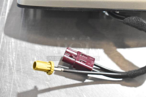 Three auction items: vent, license plate frame, and connectors. Yellow and red connectors in focus, condition unknown.