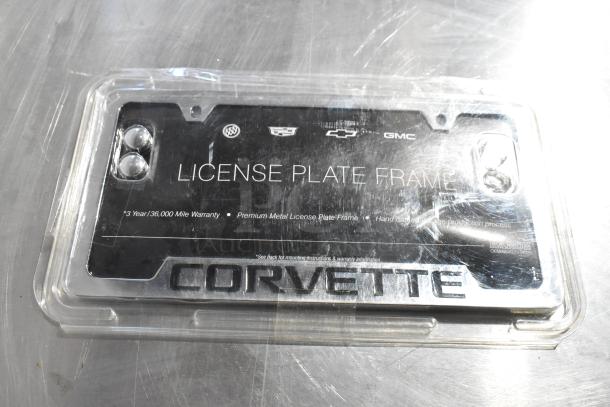 Corvette license plate frame in packaging, features 3-year/36,000-mile warranty and premium metal design, by Baron.