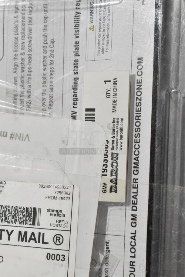 License plate frame set, includes vent, new condition. Marked GM Accessories Zone, made in China. Quantity: 1.