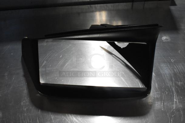 Black vent cover on a metallic surface; condition appears used. Part of auction lot with license plate frame.