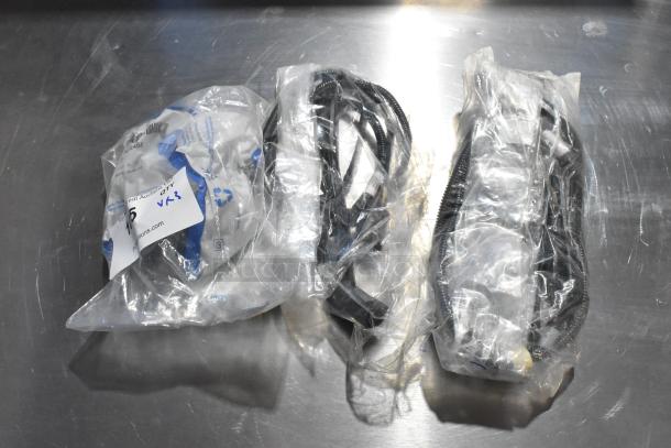 Three packs of wires in clear plastic bags on a metal surface, auction tag visible, appears new.