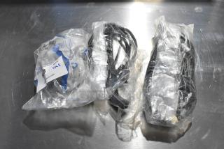 Three packs of wires in clear plastic bags on a metal surface, auction tag visible, appears new.
