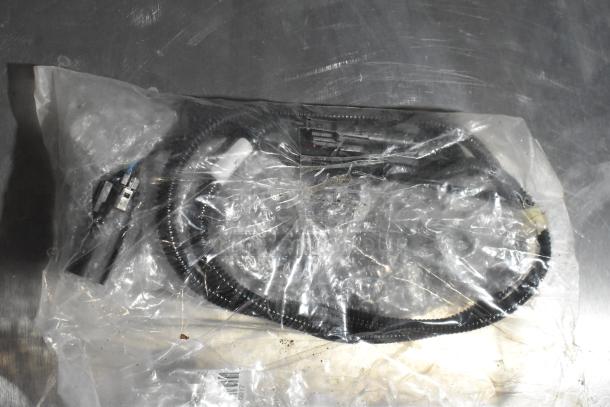 Bag containing multiple wires and connectors, sealed in plastic, possibly new condition. No visible labels or markings.