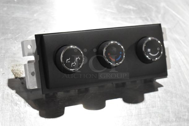 A/C and heat control panel with three knobs, black with chrome accents, in like-new condition.