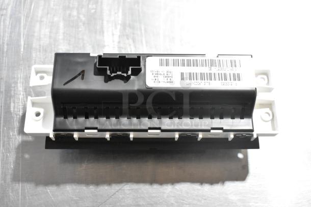 GM A/C and Heat Control Panel with visible barcode label. Black and white plastic housing. Part of auction item set.